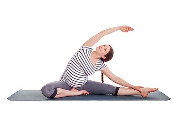 Image showing Pregnant woman doing yoga asana Parivrtta janu sirsasana