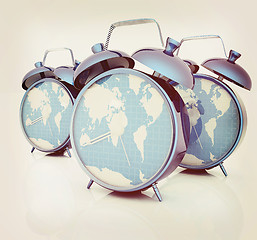 Image showing Alarm clocks of world map. 3D illustration. Vintage style.