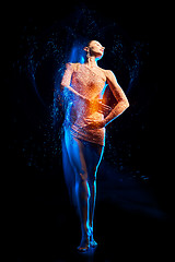 Image showing Fine art portrait of beautiful woman dancer in blue sparkles