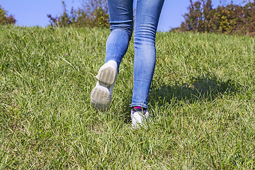 Image showing Young girl hiking in nature at green grass