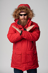 Image showing Man wearing red winter jacket gesturing stop enough hand sign