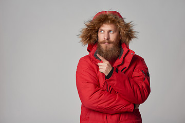 Image showing Pensive bearded man in red winter jacket