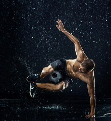 Image showing Water drops around football player under water