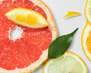 Image showing Background of citrus fruit slices, with lemons, oranges and grapefruit