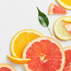 Image showing Close up of fresh citrus slices and leaf