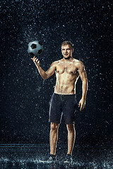 Image showing Water drops around football player under water