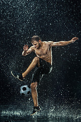 Image showing Water drops around football player under water