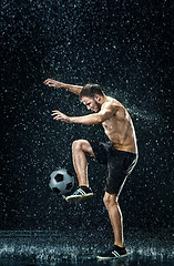 Image showing Water drops around football player under water