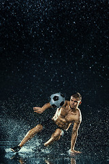 Image showing Water drops around football player under water