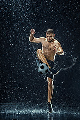 Image showing Water drops around football player under water