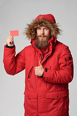 Image showing Man wearing red winter Alaska jacket with fur hood on