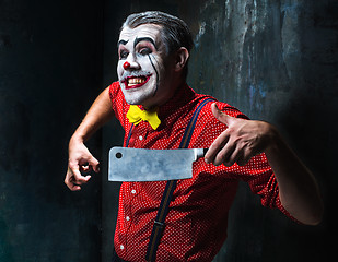 Image showing The crazy clown holding a knife on dack. Halloween concept