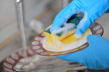 Image showing Woman hands washing dishes