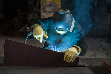 Image showing worker welding metal