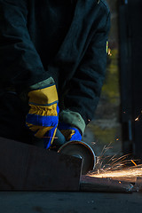 Image showing worker welding metal