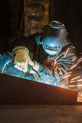 Image showing worker welding metal