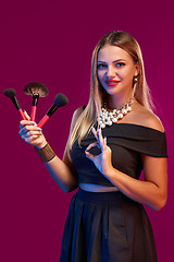 Image showing Woman makeup artist standing with brushes