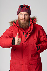 Image showing Serious bearded man showing thumb up