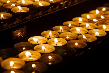 Image showing Candles in a dark church