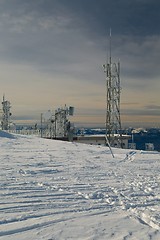 Image showing Transmitter towers on a hill in winter