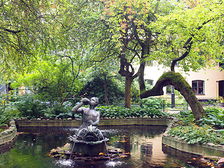 Image showing park with pond and statue fountain off shopping street Drottning