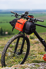 Image showing Bicycle with orange bags for travel