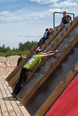 Image showing Athlete gets on inclined wall by means of bar