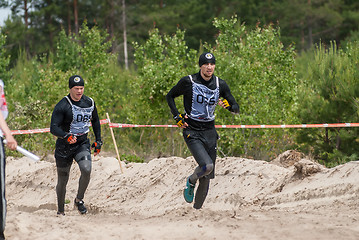 Image showing Sportsmen run between stages in extrim race.Tyumen