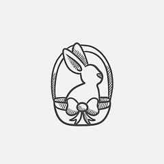 Image showing Easter bunny sitting in basket sketch icon.