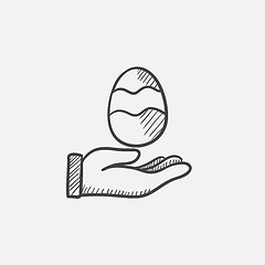 Image showing Hand holding easter egg sketch icon.