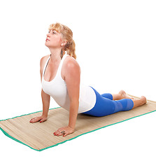 Image showing Yoga trainer lying on stomach.