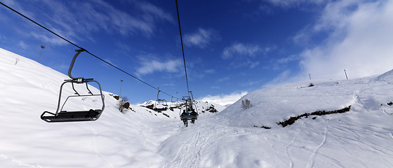 Image showing Panoramic view on chair-lift at ski resort at sun winter day