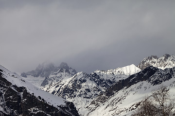 Image showing Snow sunlight mountain in fog at gray day before rain