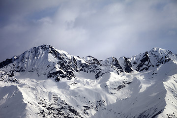 Image showing Sunlight winter mountains and sky with clouds