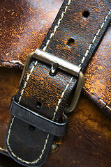 Image showing old worn leather bag buckle detail