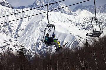 Image showing Father and daughter on ski-lift at nice sunny day