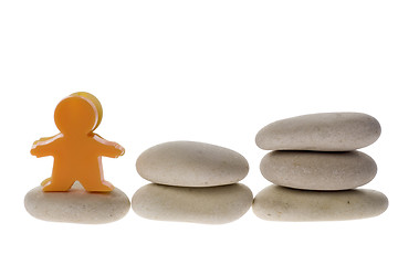 Image showing Figurine on stack of pebble