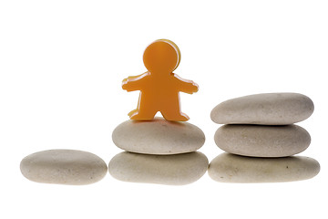 Image showing Figurine on stack of pebble