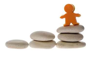 Image showing Figurine on stack of pebble