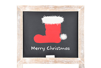 Image showing Christmas greetings with Santas hat on blackboard