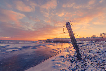 Image showing Fence post by a frozen lake