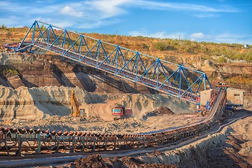 Image showing Long conveyor belt transporting ore