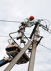 Image showing Electrician working at a pillar