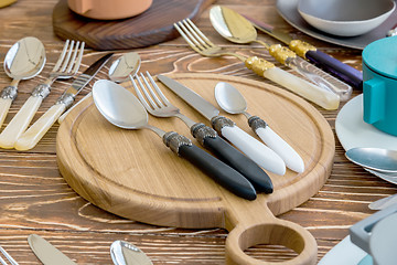 Image showing Fork Spoon Table Knife on the wooden Cutting board