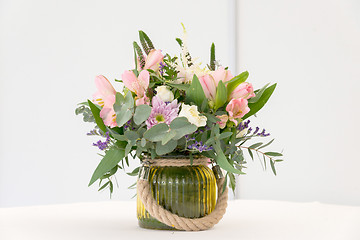 Image showing beautiful flower arrangement on white festive table