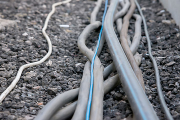 Image showing trail of power electrical cables on the ground