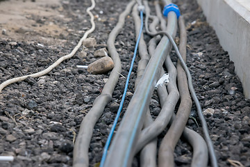 Image showing trail of power electrical cables on the ground