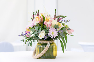 Image showing beautiful flower arrangement on white festive table