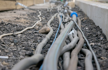 Image showing trail of power electrical cables on the ground