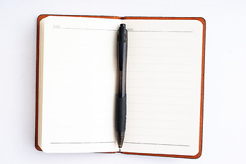 Image showing notepad with pen isolated